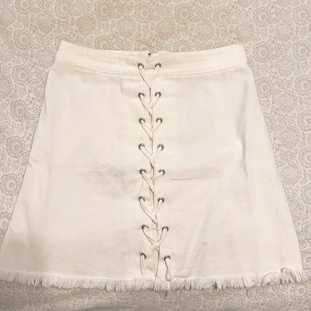 White skirt with frayed hem and lace-up detail